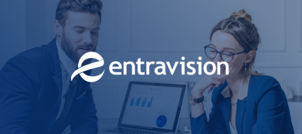 entravision logo on top of image of two coworkers looking at laptop