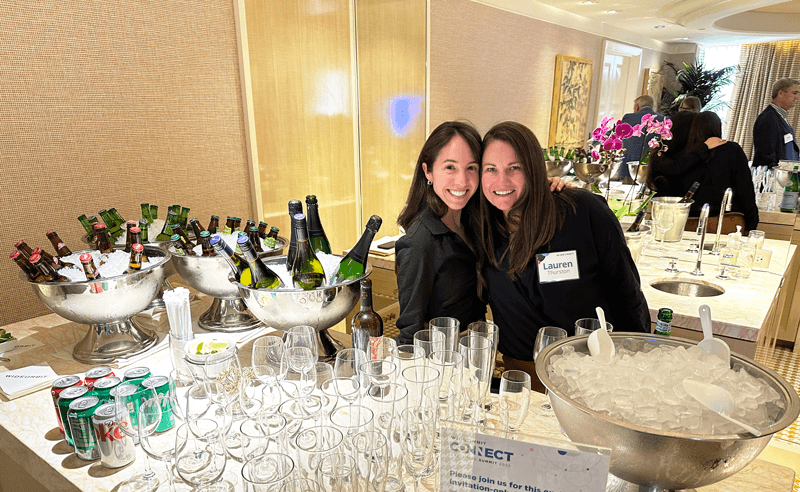2 smiling WideOrbit employees at a company event