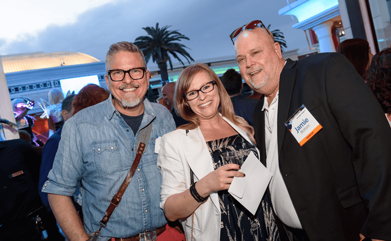 3 smiling WideOrbit employees at the NAB Show 2023