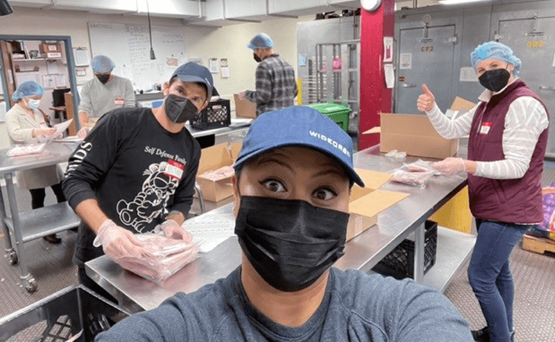 3 WideOrbit employees working at a kitchen for a volunteer event
