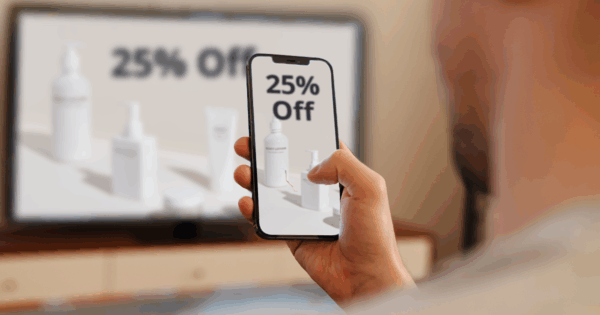 Computer screen with mirror image on phone.