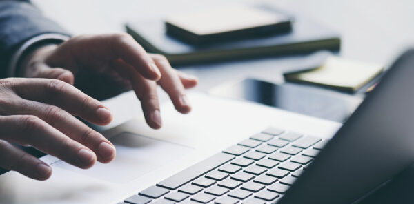 hands typing on a keyboard